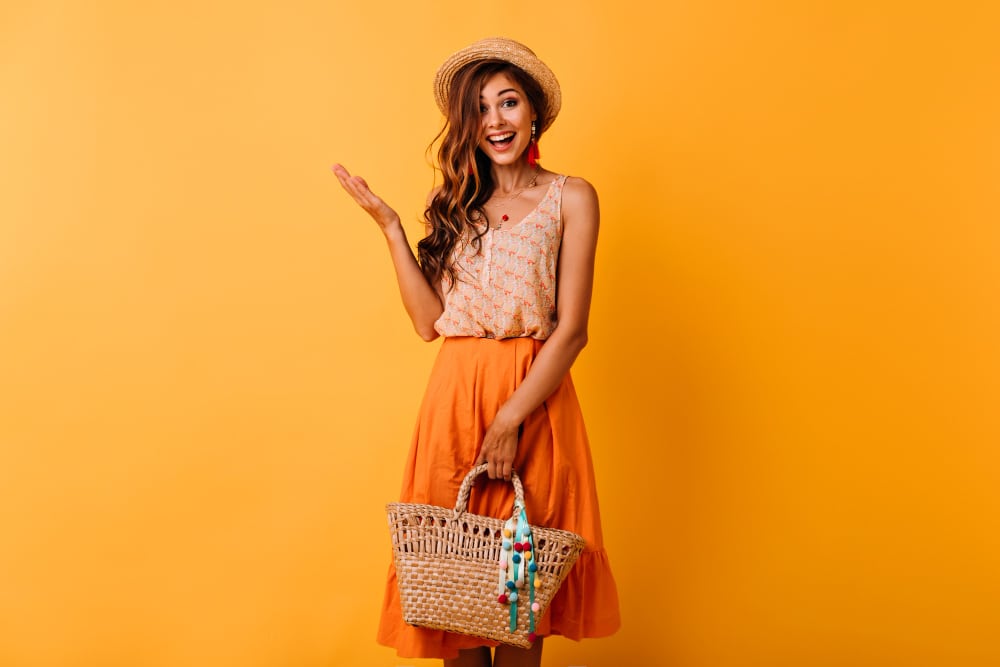 excited-ginger-lady-in-hat-holding-straw-bag-ecstatic-long-haired-girl-in-summer-outfit-enjoying-good-day
